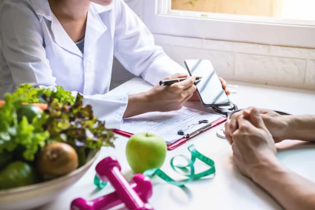 Fresh salad, an apple and a measuring tape on a table