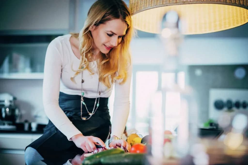 Dietary aide preparing fresh vegetables in a kitchen