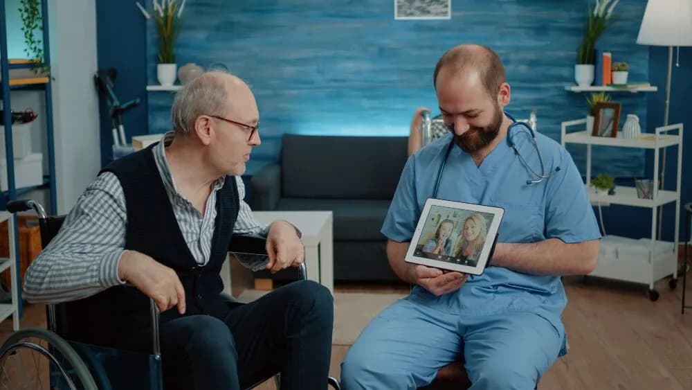 Personal support worker showing a tablet to an older man